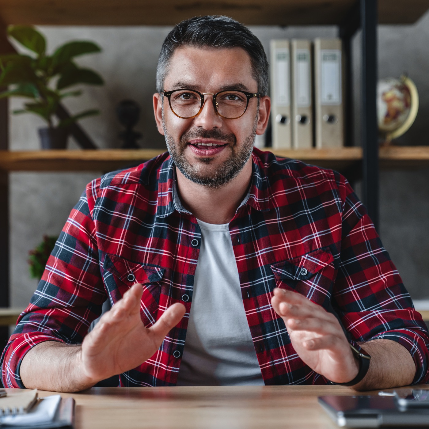 smiling young businessman sit at desk talk on webc 2022 06 21 17 57 32 utc.jpg